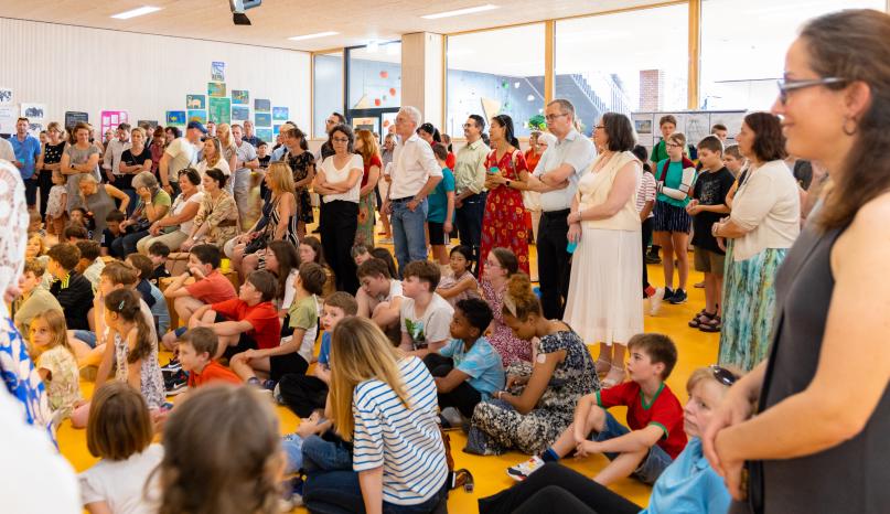 Kinder und Eltern in der Aula zusammen